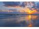 Beautiful sunset on a beach, with colorful reflections on the wet sand and gentle waves at 5432 Cape Leyte Dr, Sarasota, FL 34242