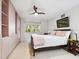 Bright bedroom features built-in storage, neutral walls, and a window with backyard views at 5432 Cape Leyte Dr, Sarasota, FL 34242