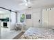 Bright bedroom featuring a barn door leading to the kitchen, a workspace and neutral decor at 5432 Cape Leyte Dr, Sarasota, FL 34242