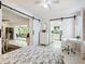 Bright bedroom featuring barn doors leading to kitchen and dining area, with a neutral décor and workstation at 5432 Cape Leyte Dr, Sarasota, FL 34242