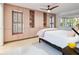 Modern bedroom with built-in storage cabinets, neutral decor, and a view from the large windows at 5432 Cape Leyte Dr, Sarasota, FL 34242