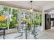 Bright breakfast nook features glass table set and garden views at 5432 Cape Leyte Dr, Sarasota, FL 34242