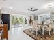 Spacious dining area with a ceiling fan, neutral walls, and adjacent living spaces at 5432 Cape Leyte Dr, Sarasota, FL 34242