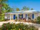 Charming home with a brick-paved driveway, beautiful landscaping, and bright blue shutters at 5432 Cape Leyte Dr, Sarasota, FL 34242