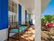 Cozy front porch featuring comfortable seating with blue striped cushions at 5432 Cape Leyte Dr, Sarasota, FL 34242