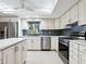 Modern kitchen with white cabinetry, stainless steel appliances, and a grey subway tile backsplash at 5432 Cape Leyte Dr, Sarasota, FL 34242