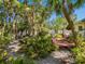 Outdoor patio surrounded by lush tropical landscaping, creating a serene and private setting at 5432 Cape Leyte Dr, Sarasota, FL 34242