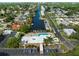 Aerial shot of a waterfront community highlighting a canal, pool, parking, and lush greenery at 5521 Riverbluff Cir # V-10, Sarasota, FL 34231