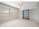 Bedroom with ceiling fan and large window features a built-in Murphy bed and closet at 5521 Riverbluff Cir # V-10, Sarasota, FL 34231