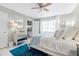 Bright bedroom featuring a cozy bed, sheer curtains, and a modern dresser, creating a serene space at 5521 Riverbluff Cir # V-10, Sarasota, FL 34231