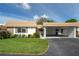 Charming home featuring a covered carport, stone accents, and well-maintained landscaping at 5521 Riverbluff Cir # V-10, Sarasota, FL 34231