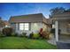 Charming home with tidy lawn, lush garden, and covered entrance at 5521 Riverbluff Cir # V-10, Sarasota, FL 34231