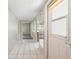 Bright hallway with white tile flooring leading to other rooms in the home at 5521 Riverbluff Cir # V-10, Sarasota, FL 34231