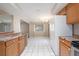 Open kitchen with view to the dining area, white appliances, and tile floors at 5521 Riverbluff Cir # V-10, Sarasota, FL 34231