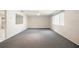 Open living room provides a comfortable space with a large window and neutral gray carpeting at 5521 Riverbluff Cir # V-10, Sarasota, FL 34231