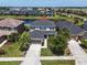 Aerial view of a two-story home with a dark roof, attached garage, and a well-maintained lawn at 5740 Sunflower Cir, Sarasota, FL 34238