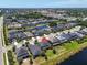 Aerial view of a two-story home in a community with lush landscaping and serene water views at 5740 Sunflower Cir, Sarasota, FL 34238