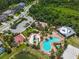 Aerial shot of the community pool, playground, and recreational area surrounded by lush greenery and palm trees at 5740 Sunflower Cir, Sarasota, FL 34238