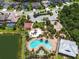 Overhead shot of a community pool, playground, and amenities nestled in a neighborhood with lush landscaping and mature trees at 5740 Sunflower Cir, Sarasota, FL 34238