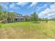Spacious backyard showcasing a lush lawn, waterfront views, and charming exterior of a beautiful suburban home at 5740 Sunflower Cir, Sarasota, FL 34238
