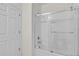 Bright bathroom with glass shower doors and white subway tile extending to the ceiling at 5740 Sunflower Cir, Sarasota, FL 34238