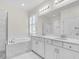 Luxurious bathroom featuring dual sinks, a soaking tub and a glass enclosed shower at 5740 Sunflower Cir, Sarasota, FL 34238