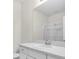 Clean bathroom featuring white cabinets, a light countertop, and a sliding glass shower door at 5740 Sunflower Cir, Sarasota, FL 34238