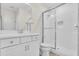 Bathroom featuring a shower with glass doors, and a matching white vanity at 5740 Sunflower Cir, Sarasota, FL 34238
