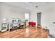 Spacious bonus room featuring hardwood floors, a work area and an adjacent bathroom at 5740 Sunflower Cir, Sarasota, FL 34238