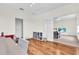Bonus room with hardwood floors leading to the living room, featuring a staircase at 5740 Sunflower Cir, Sarasota, FL 34238