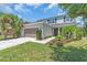 Charming two-story home boasts a well-manicured lawn, lush landscaping, and an attached two-car garage at 5740 Sunflower Cir, Sarasota, FL 34238