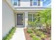 Elegant front entrance showcasing a well-maintained landscape with lush greenery and a welcoming front door at 5740 Sunflower Cir, Sarasota, FL 34238