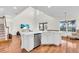 Open layout featuring kitchen island, stainless steel appliances, and living room with natural light at 5740 Sunflower Cir, Sarasota, FL 34238