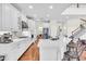 Bright kitchen features white cabinets, stainless steel appliances, and a large island with seating at 5740 Sunflower Cir, Sarasota, FL 34238
