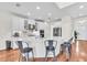 Modern kitchen with white cabinetry, stone countertops, stainless appliances and an island with seating at 5740 Sunflower Cir, Sarasota, FL 34238