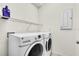 Laundry room featuring a washer, dryer and a wire shelf at 5740 Sunflower Cir, Sarasota, FL 34238