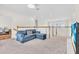Cozy upstairs living room with a comfortable blue couch and a neutral carpet at 5740 Sunflower Cir, Sarasota, FL 34238