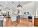 Open living space with kitchen island, stairs, and living room with plenty of natural light at 5740 Sunflower Cir, Sarasota, FL 34238
