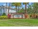 Arbor Lakes community sign with lush green lawn and colorful landscaping at 5740 Sunflower Cir, Sarasota, FL 34238