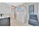 This modern bathroom features a glass shower, shower chair, and a floating vanity at 5939 Redbay Blvd, Bradenton, FL 34210