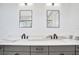 This modern bathroom features dual sinks, black fixtures and a sleek design at 5939 Redbay Blvd, Bradenton, FL 34210