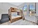 Inviting bedroom with a cozy bunk bed, abundant natural light, and a soothing atmosphere for restful nights at 5939 Redbay Blvd, Bradenton, FL 34210