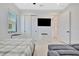 Well-lit bedroom featuring a TV, neutral color palette, and a sliding door closet for all your storage needs at 5939 Redbay Blvd, Bradenton, FL 34210