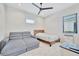 Bright bedroom featuring a cozy bed, comfortable couch, and plenty of natural light from the window at 5939 Redbay Blvd, Bradenton, FL 34210