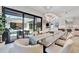 Bright dining room showcases modern pendant lighting, large glass doors to outdoor patio, and views of the modern kitchen at 5939 Redbay Blvd, Bradenton, FL 34210