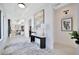 Bright foyer featuring a modern console table, elegant artwork, and open view to the kitchen and living area at 5939 Redbay Blvd, Bradenton, FL 34210