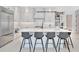 Modern kitchen with an island and bar seating, stainless steel appliances, and bright countertops at 5939 Redbay Blvd, Bradenton, FL 34210