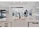 Kitchen island featuring white farmhouse sink and marble countertops, offering an open view into other living areas at 5939 Redbay Blvd, Bradenton, FL 34210