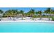 Up close view of a gorgeous lagoon and sandy beach area with many palm trees at 5939 Redbay Blvd, Bradenton, FL 34210
