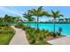 A sidewalk borders the lagoon offering a landscaped area with palm trees and plants at 5939 Redbay Blvd, Bradenton, FL 34210